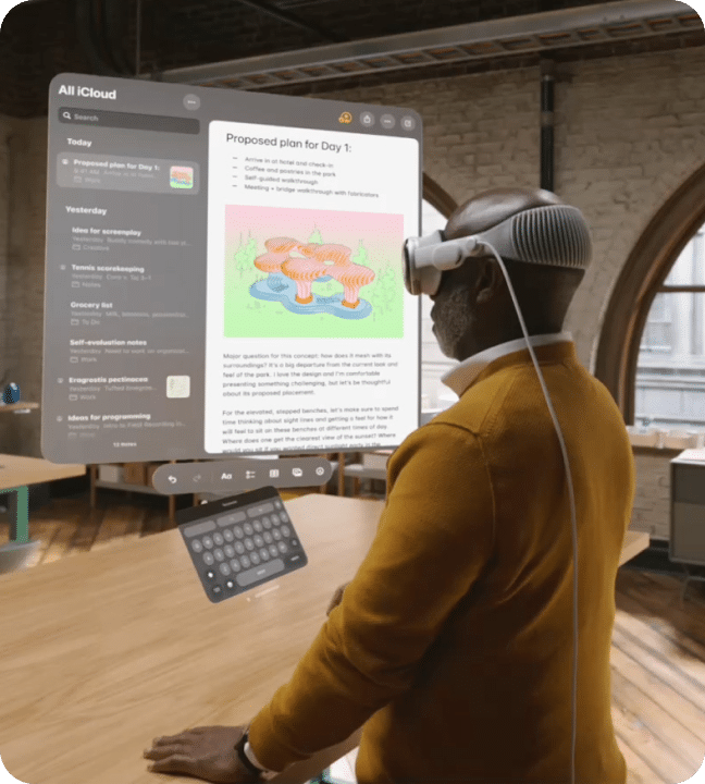 In this image, we demonstrate a person using an An image of a person wearing an Apple Vision Pro headset. He is viewing a web page floating in augmented reality.
