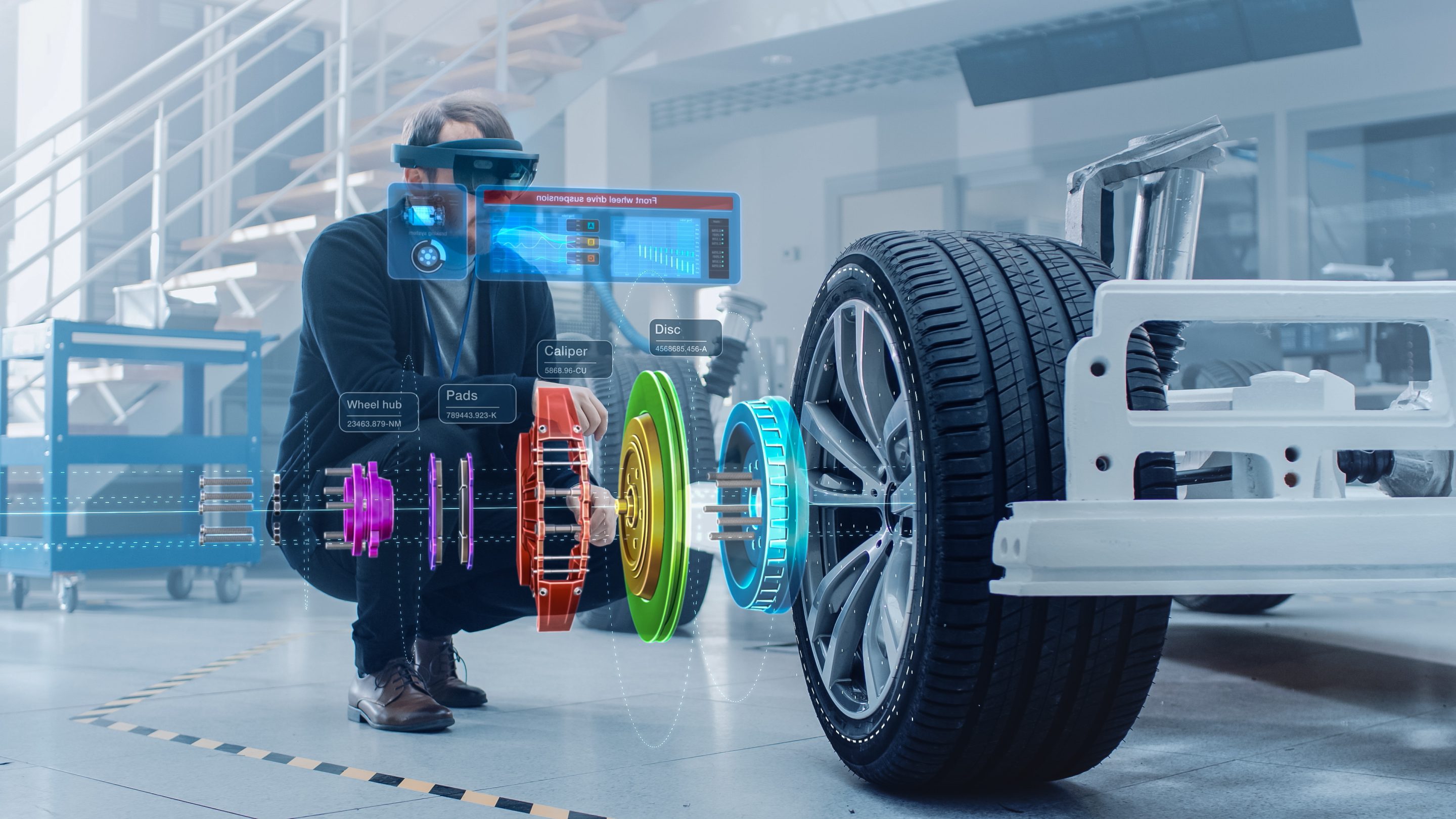 Automotive Engineer Working on Electric Car Chassis Platform, Using Augmented Reality Headset with 3D VFX Software for Development of Regenerative Braking System on a Transport Vehicle. Automotive Engineer Working on Electric Car Chassis Platform, Using Augmented Reality Headset with 3D VFX Software for Development of Regenerative Braking System on a Transport Vehicle.