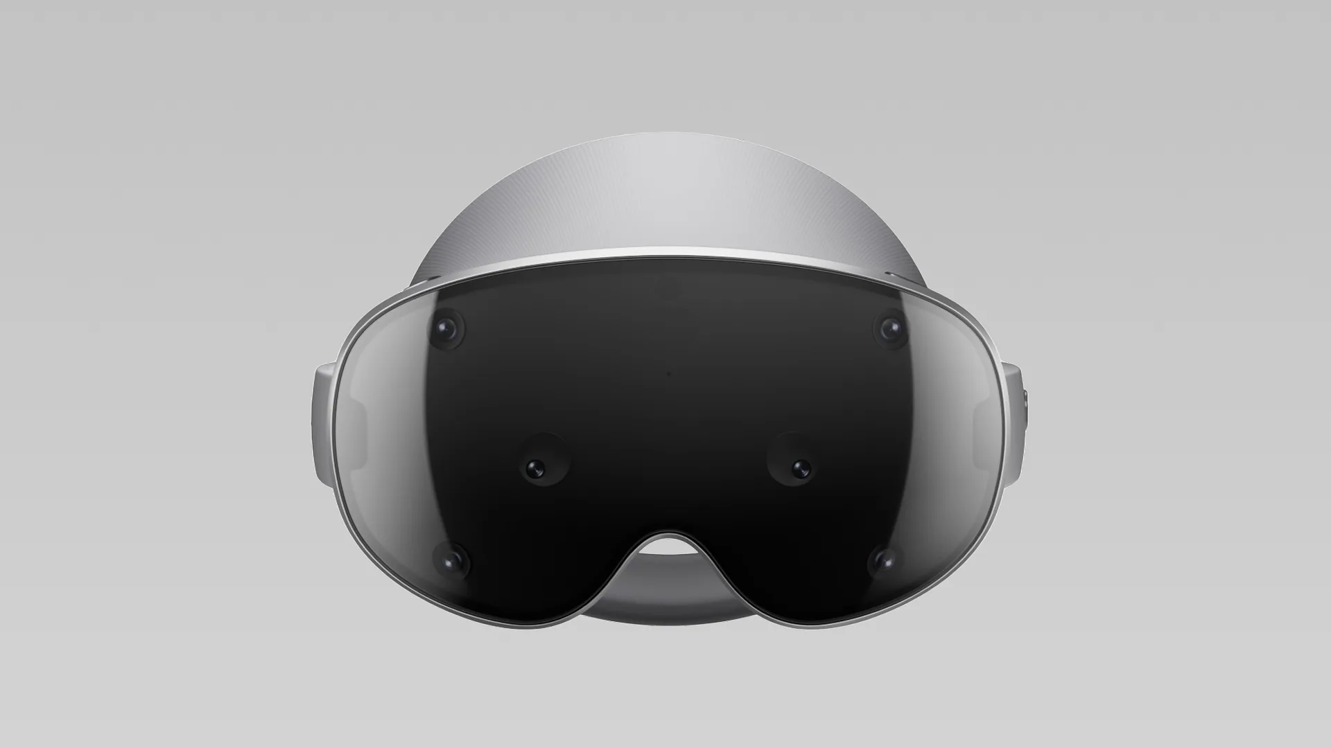 Front view of a grey mixed-reality headset with a wide tinted visor, six cameras and a fabric halo strap