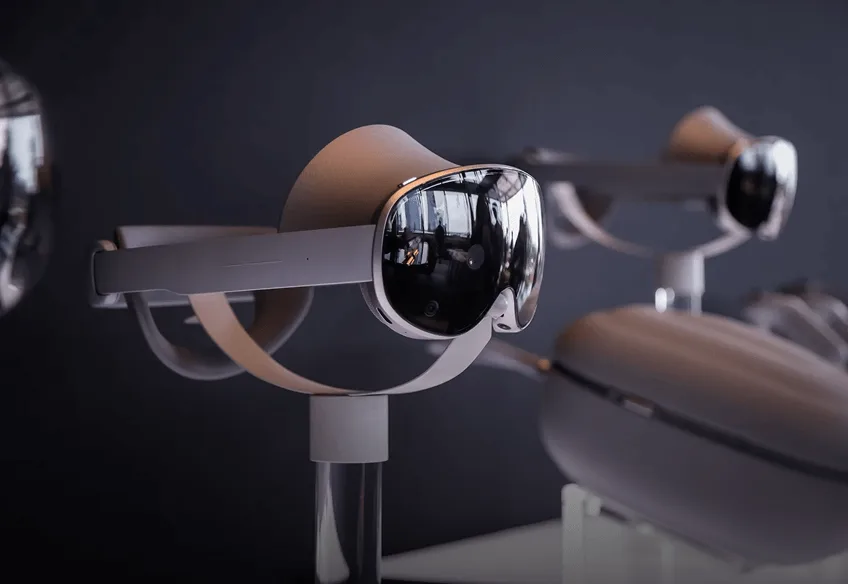 Row of visor-style mixed reality headsets on display stands against a dark backdrop