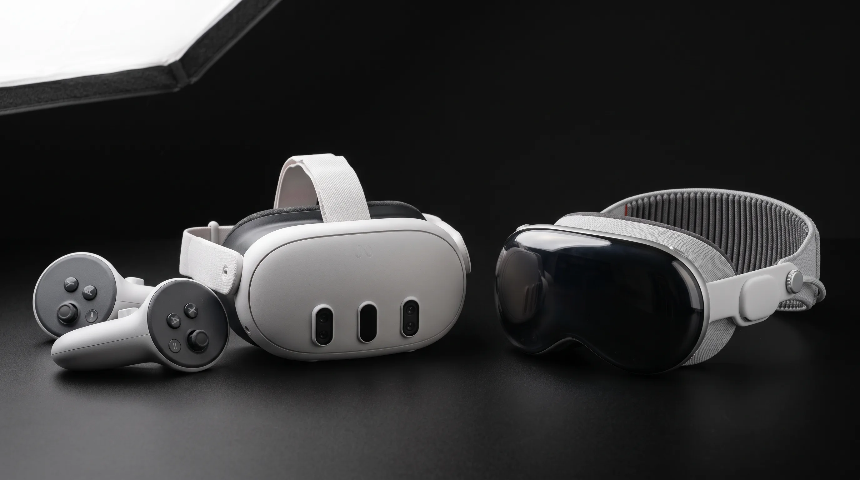 Meta Quest 3 and Apple Vision Pro headsets side by side on a clean studio surface.