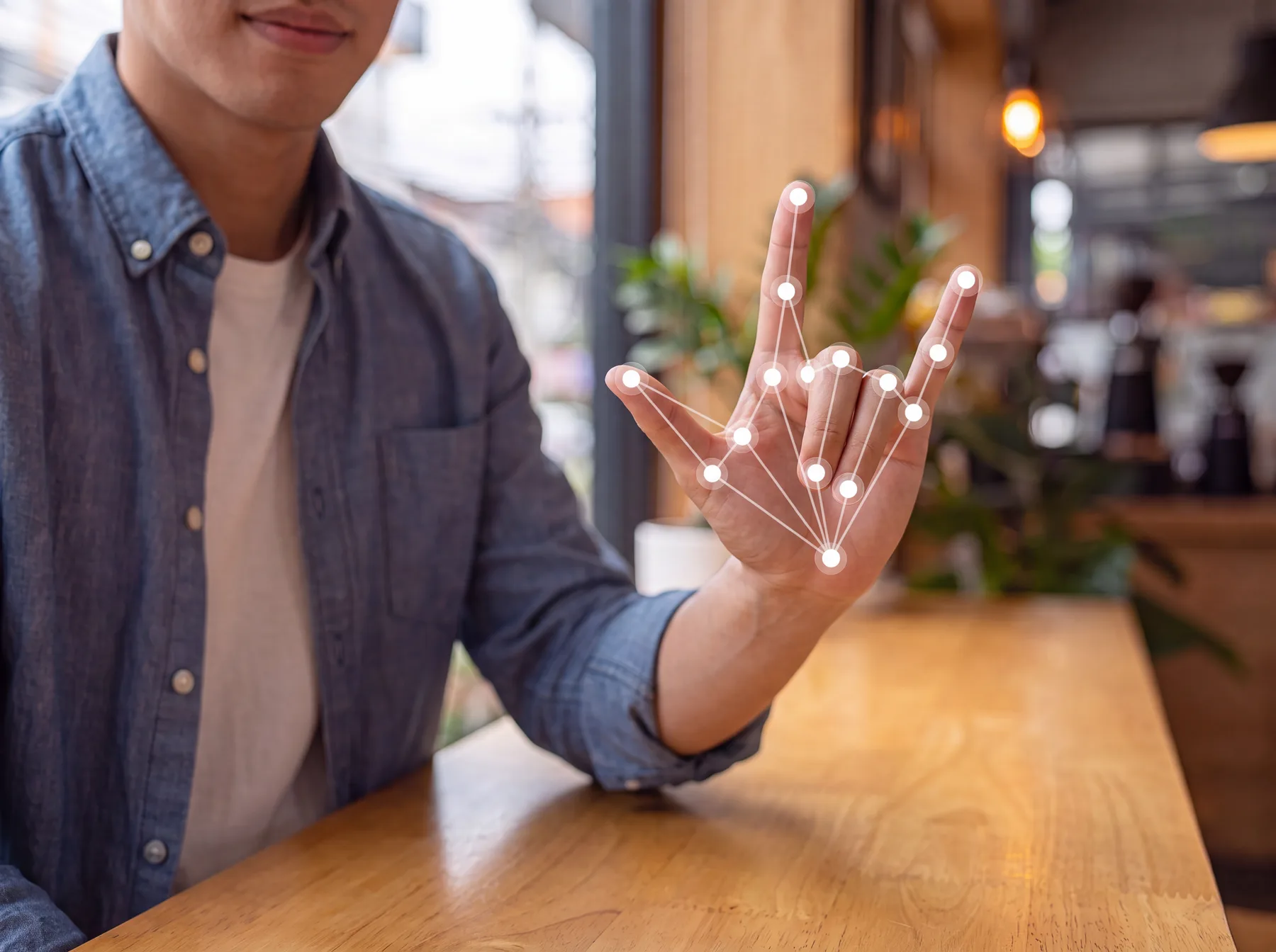 A man demonstrating sign language with hand-tracking landmarks