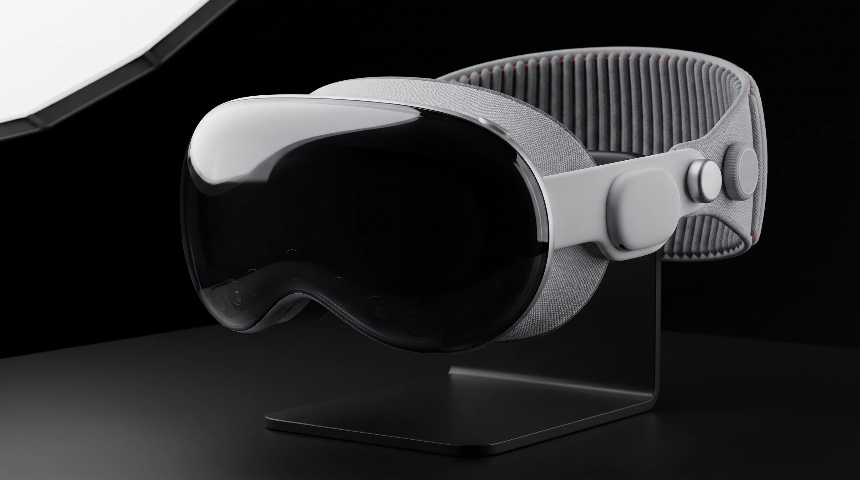 Apple Vision Pro headset resting on a stand on a studio table