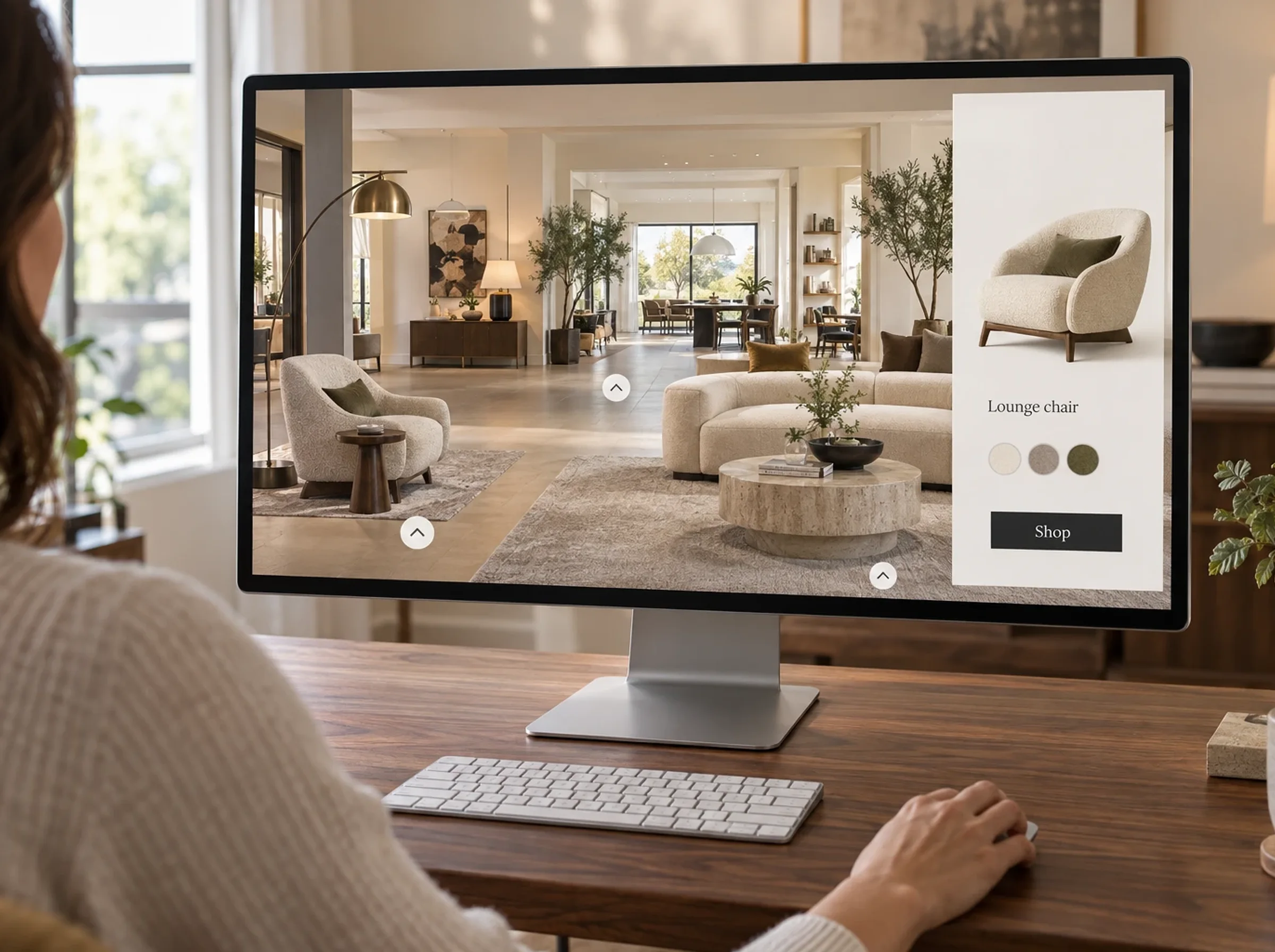 Shopper browsing a navigable virtual furniture showroom on a desktop monitor, with a lounge chair selected in a side panel