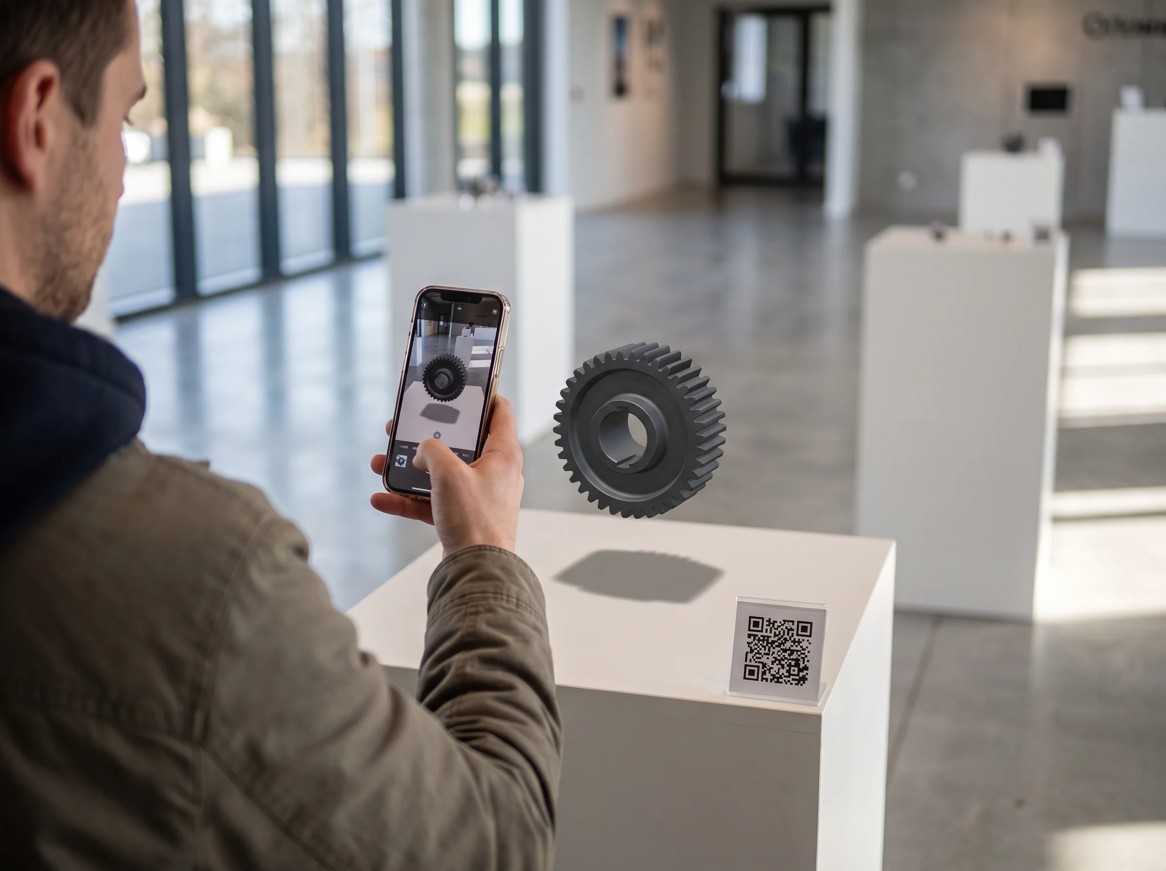Visitor scanning a QR code in a showroom to launch a full-scale 3D product on their phone