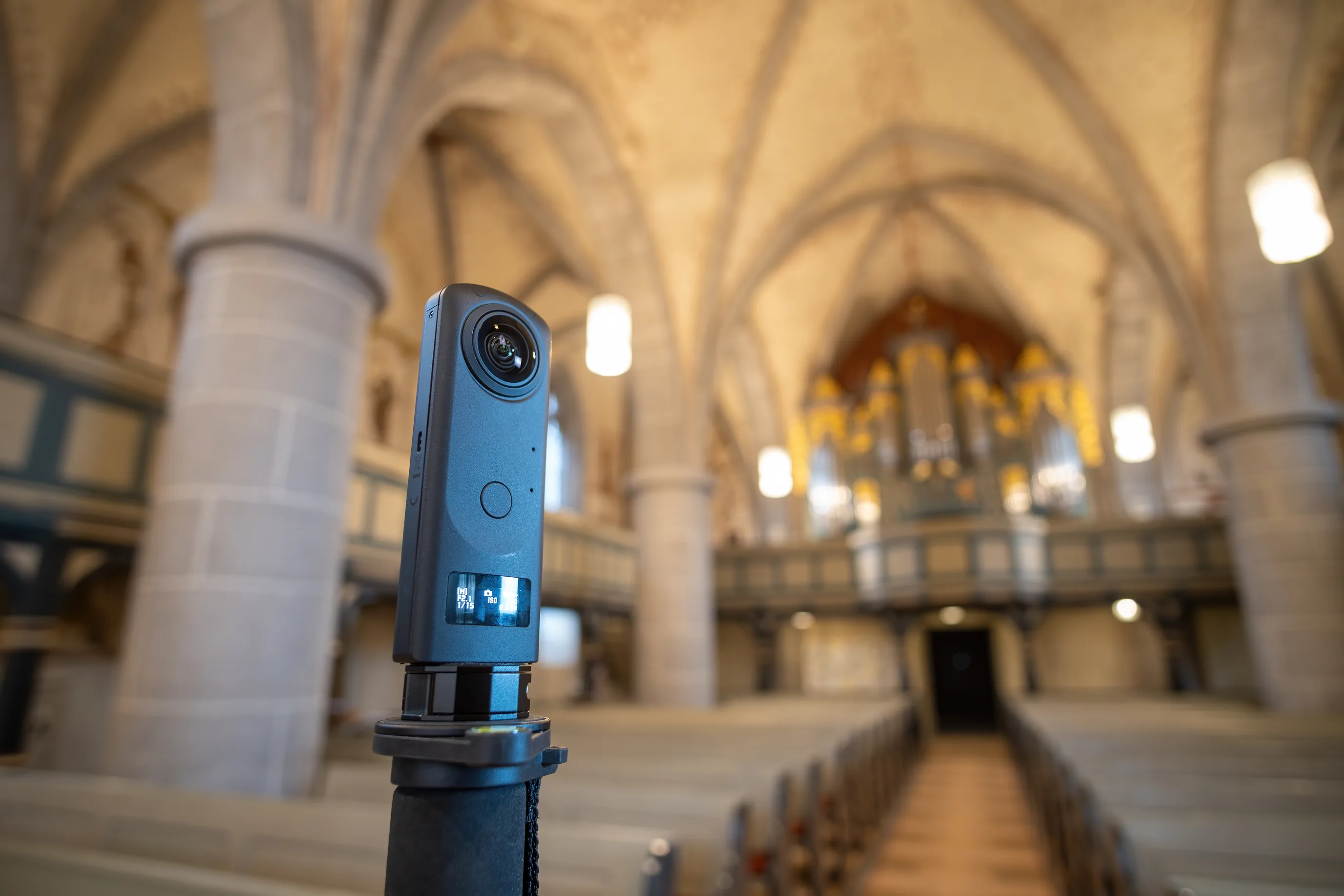 360 camera on a monopod performing reality capture of a historic church interior for a digital twin