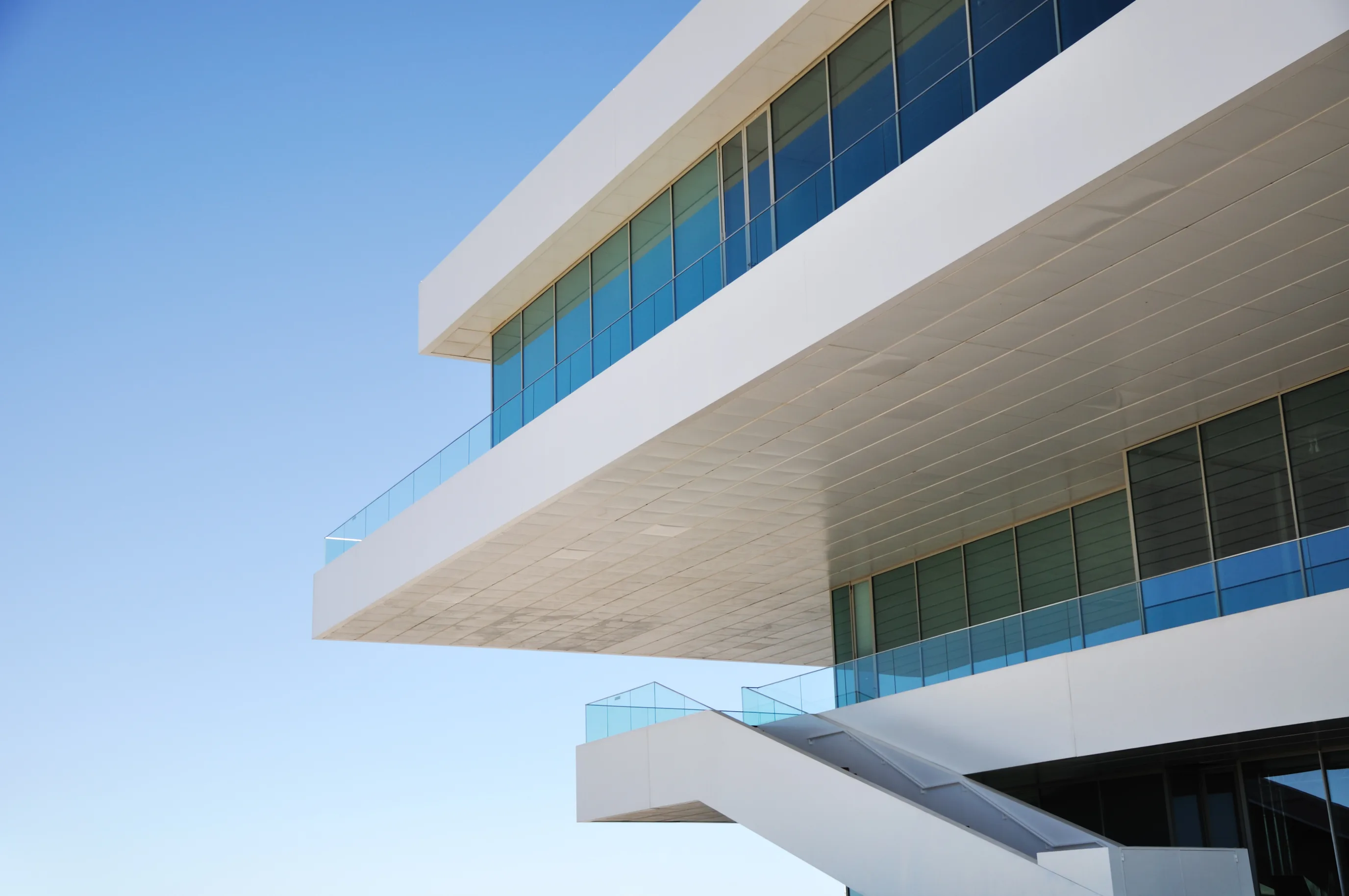 Modern commercial building with cantilevered white terraces — the kind of property captured as a real-estate digital twin