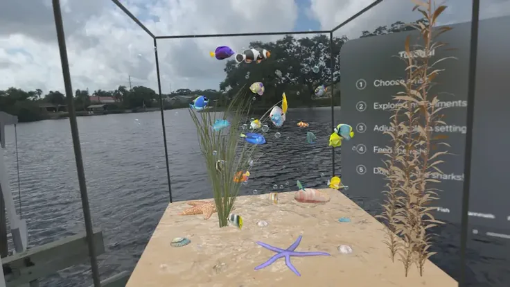 Glass aquarium frame on a lakeside deck, filled with virtual fish and coral