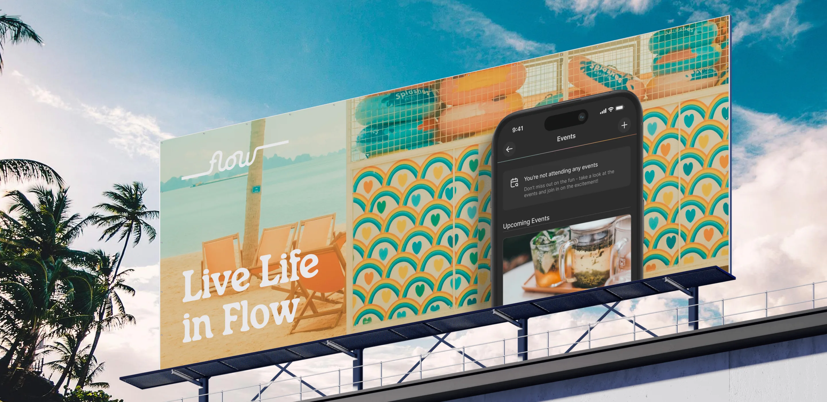 Rooftop billboard reading Live Life in Flow, with beach chairs, rainbow-heart tiles and the Flow Life Events screen on a phone