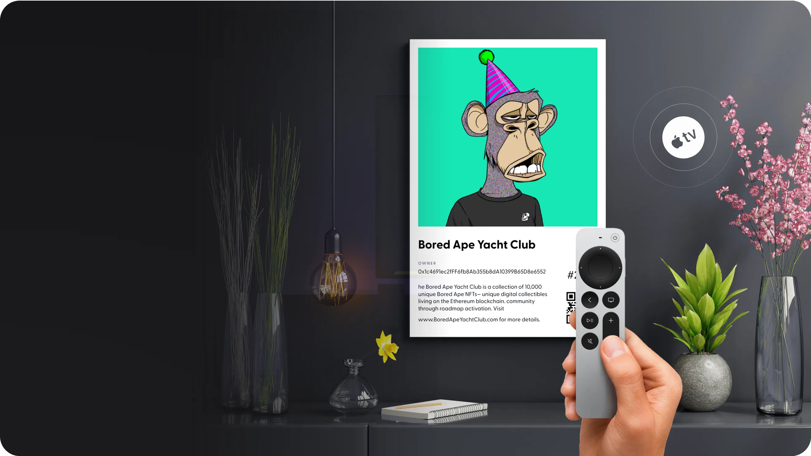 A framed Bored Ape Yacht Club NFT on a living-room wall, with a hand holding an Apple TV remote