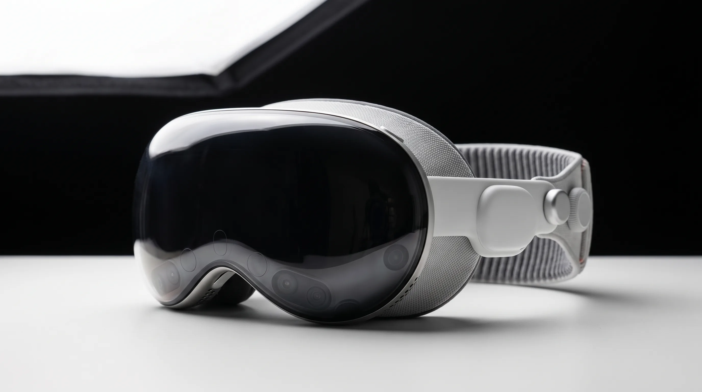 Apple Vision Pro headset on a studio surface showing aluminium frame and lens system